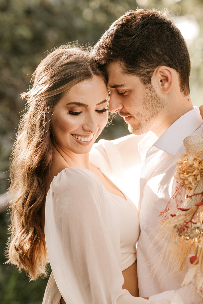 Happy couple hugging outside in daytime