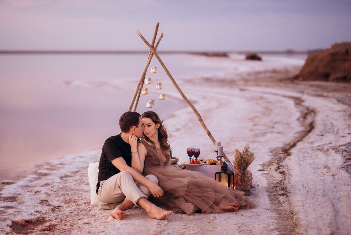 young couple having a picnic on the beach