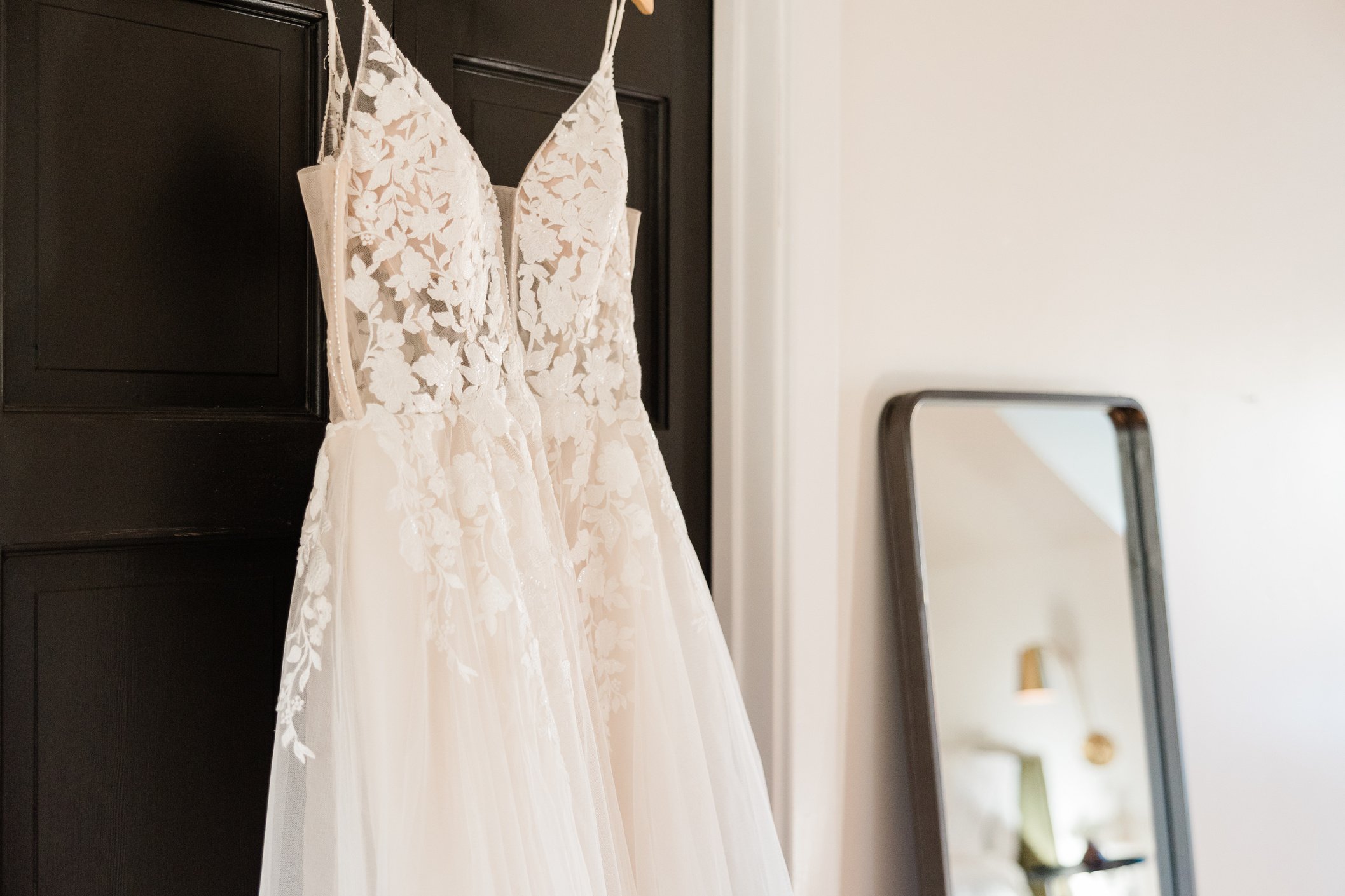 Wedding Gown Hanging by the Door Indoors